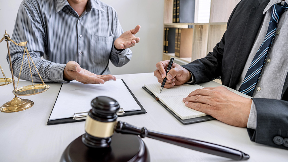 a group of people discussing on a table about legal matters