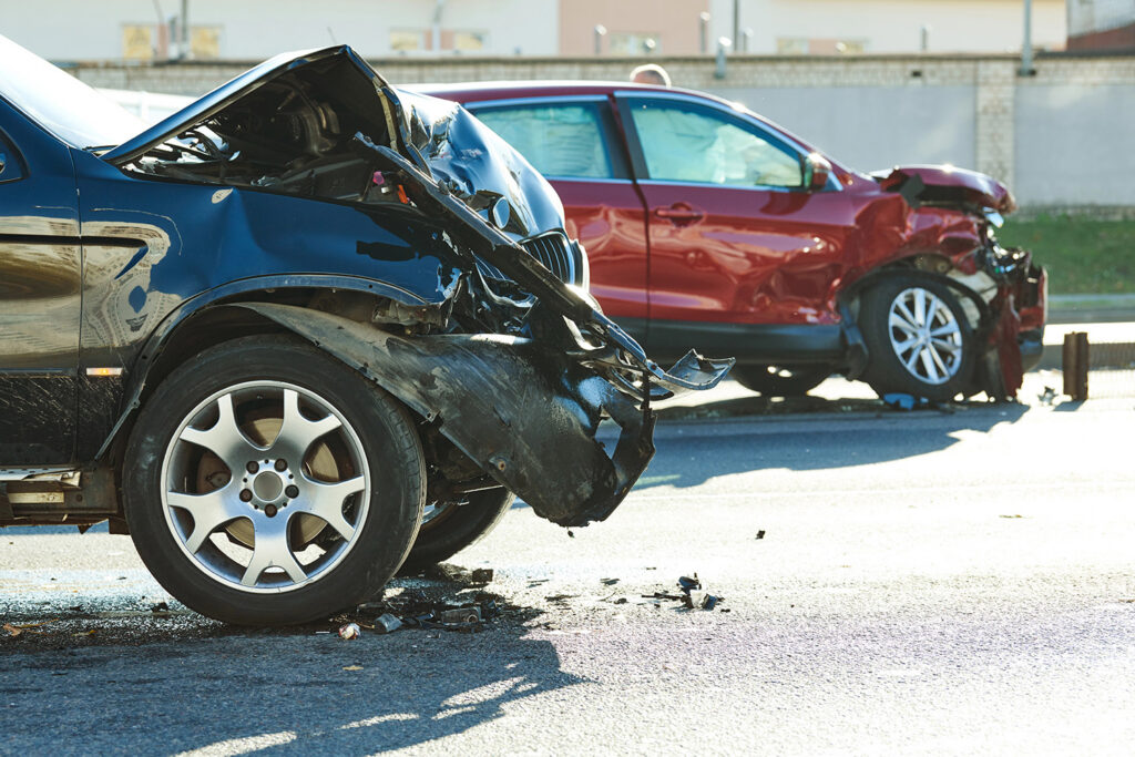 car crash accident. Car collision on city street. Two damaged automobiles